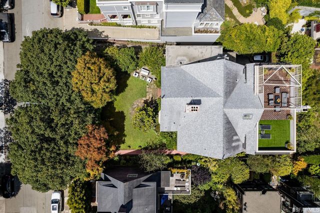 an aerial view of a house with a yard