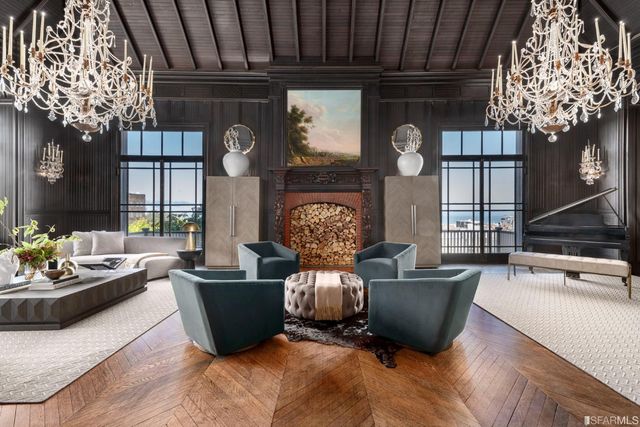 a living room with furniture and a chandelier