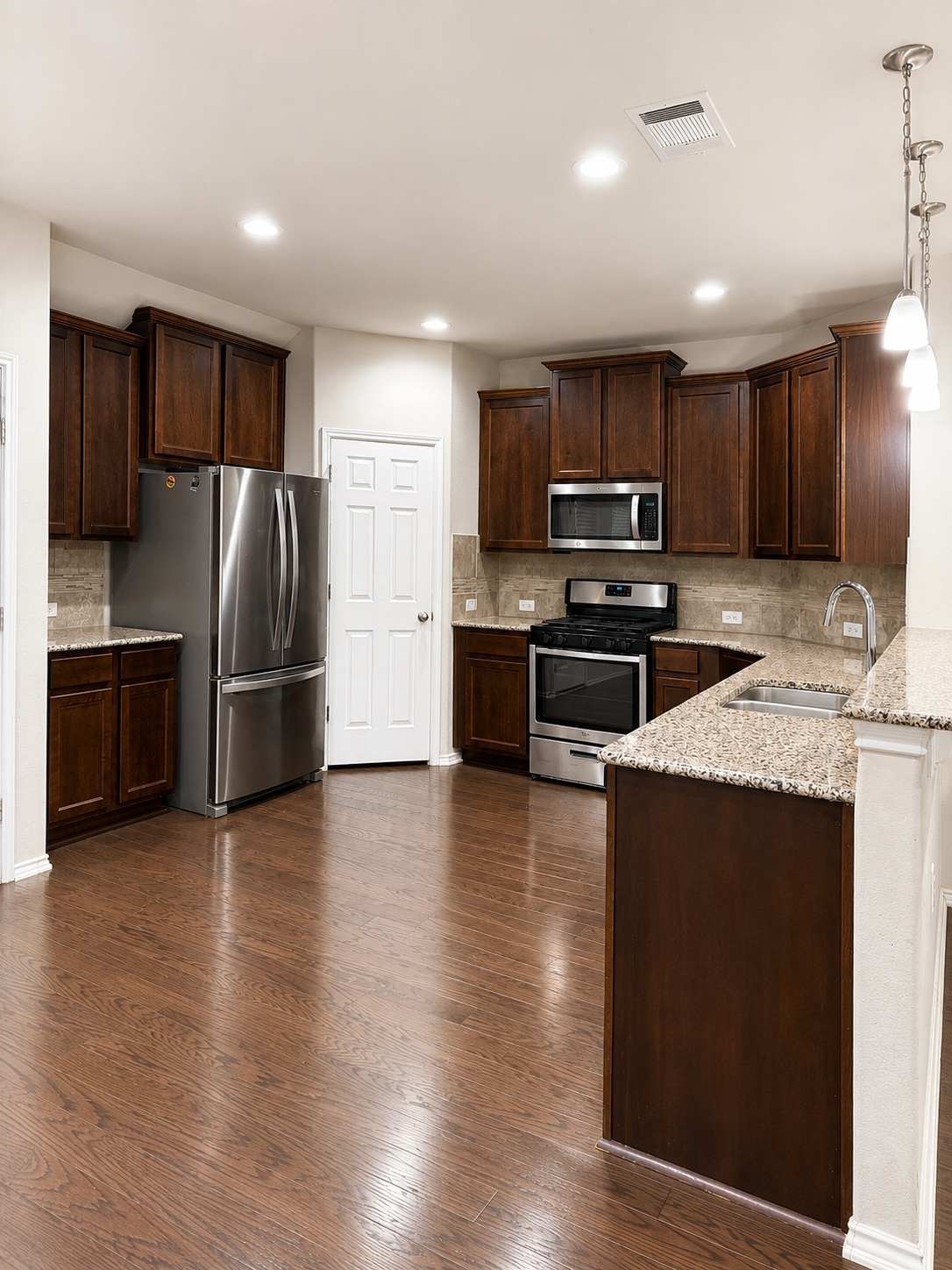 187 Limerick Road Buda, TX 78610 - Photo 5 of 18 A well-appointed kitchen features stainless steel appliances and abundant cabinetry.