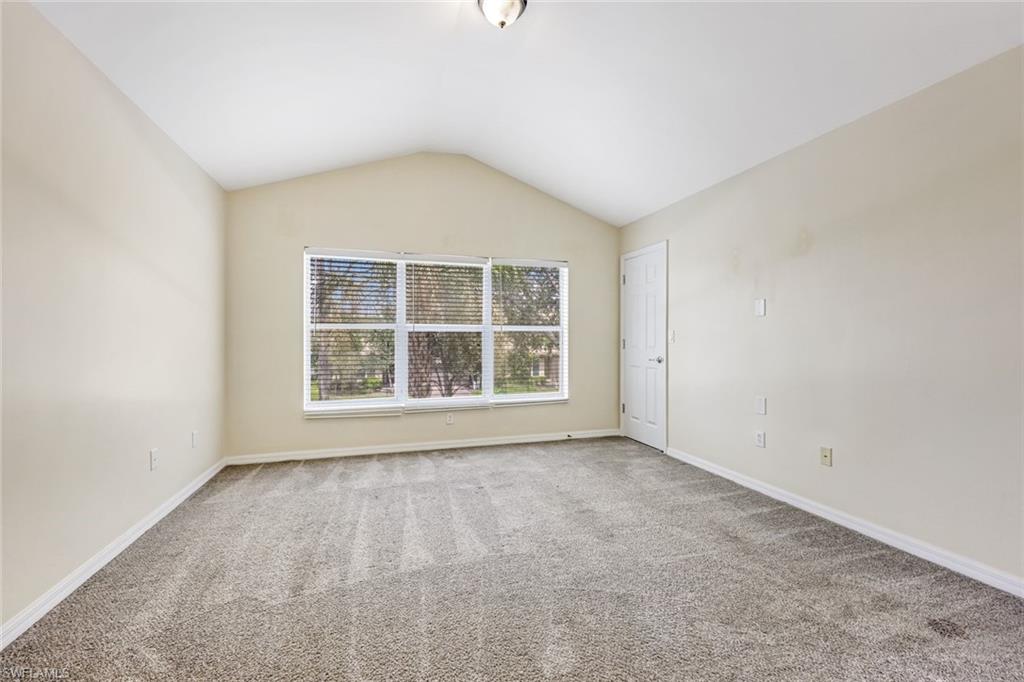 16162 Ravina Way, Unit 65 Naples, FL 34110 - Photo 13 of 22 an empty room with a window