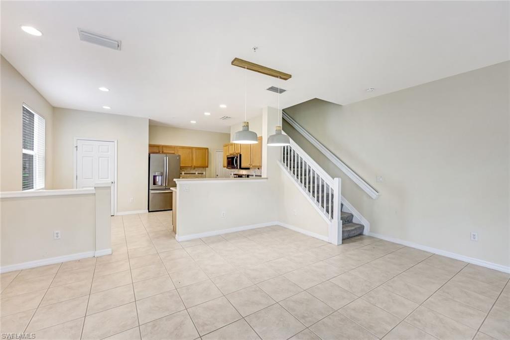 16162 Ravina Way, Unit 65 Naples, FL 34110 - Photo 5 of 22 a view of a hallway with kitchen and entryway