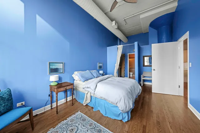 a bedroom with a large bed and a window