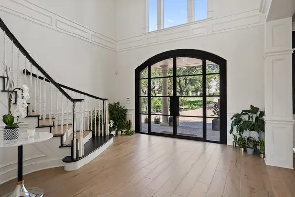 a view of an entryway with wooden floor and windows