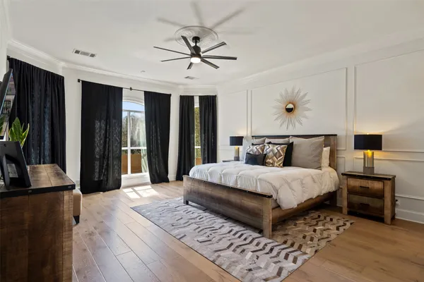 a bedroom with a large bed and a chandelier