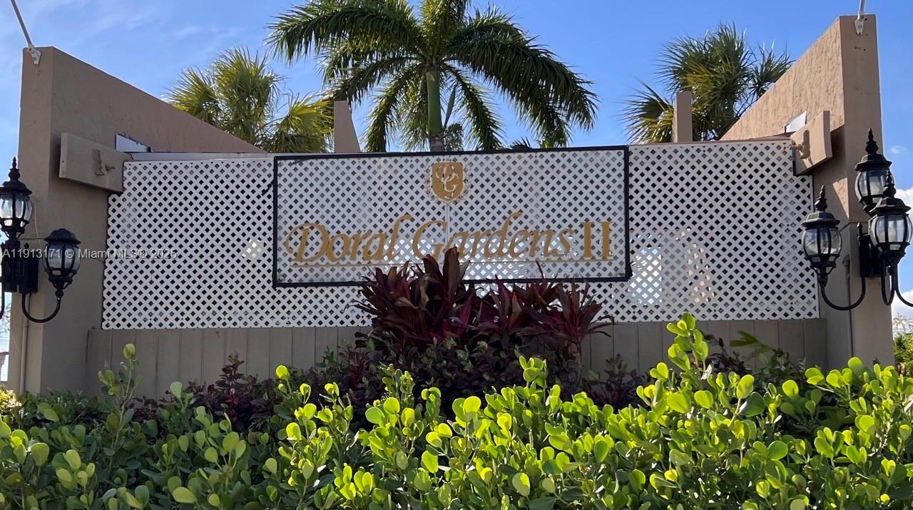 a view of a swimming pool with a flower garden