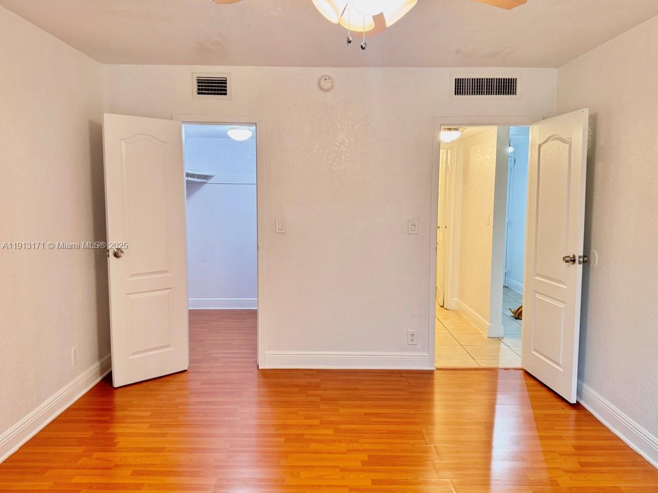 5201 Geneva Court, Unit 307 Doral, FL 33166 - Photo 11 of 19 a view of an empty room with wooden floor and a bathroom