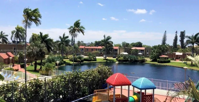 a lake view with boat and palm trees
