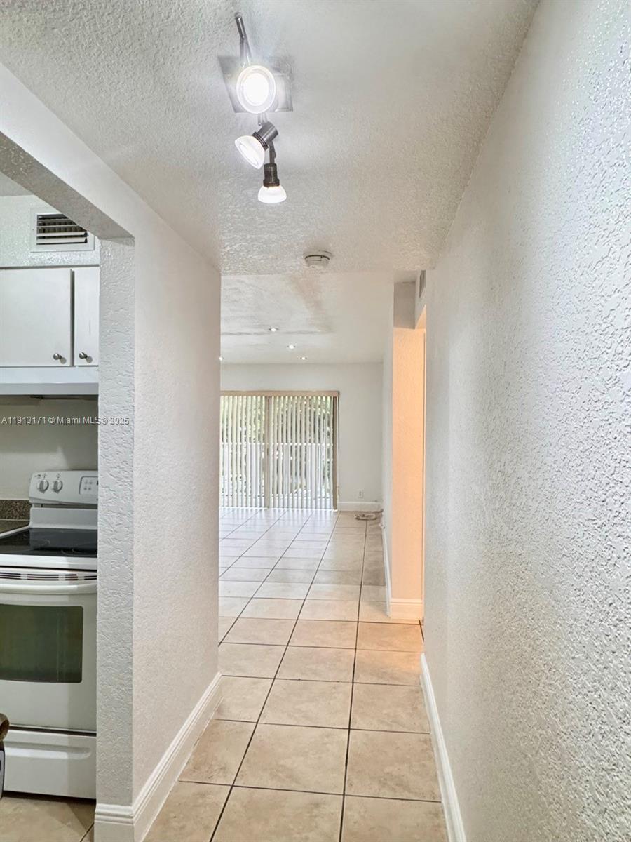 5201 Geneva Court, Unit 307 Doral, FL 33166 - Photo 2 of 19 a view of an empty room with a window