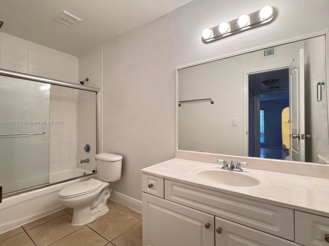 5201 Geneva Court, Unit 307 Doral, FL 33166 - Photo 8 of 19 a bathroom with a sink a toilet and shower