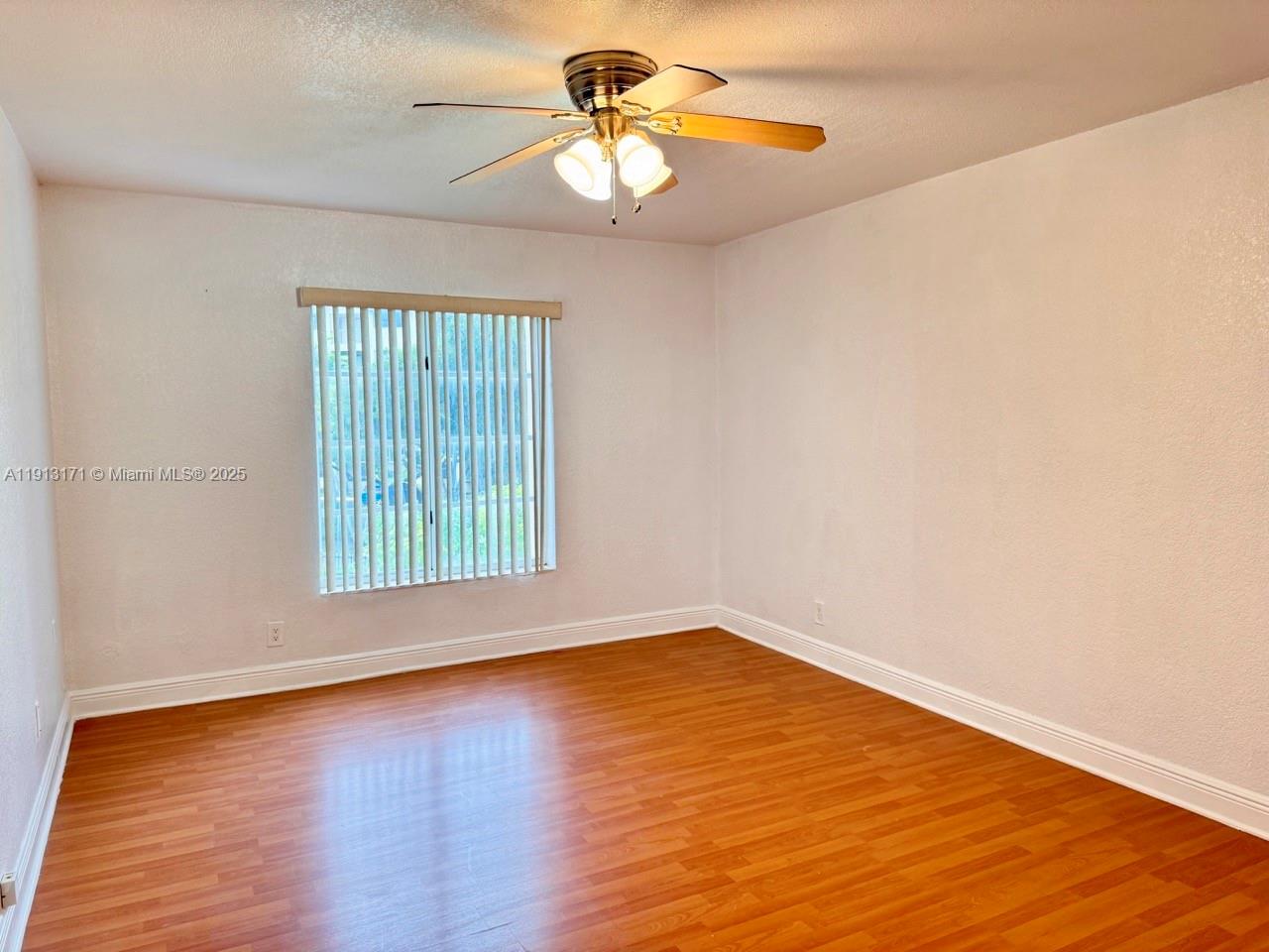 5201 Geneva Court, Unit 307 Doral, FL 33166 - Photo 10 of 19 a view of a room with wooden floor and a window