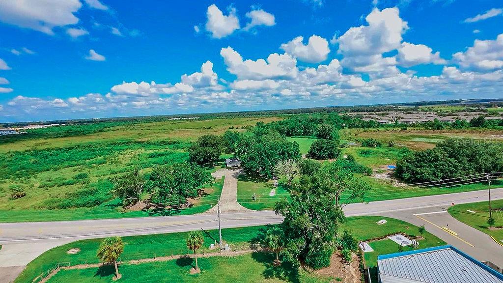 1030 Chalet Suzanne Road Lake Wales, FL 33859 - Photo 3 of 5 a view of a house with a yard and a fountain