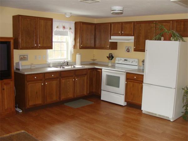 4 Kerri Lane Whitman, MA 02382 - Photo 12 of 30 a kitchen with a sink a stove a refrigerator and cabinets