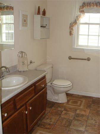 4 Kerri Lane Whitman, MA 02382 - Photo 14 of 30 a bathroom with a granite countertop toilet a sink and a window