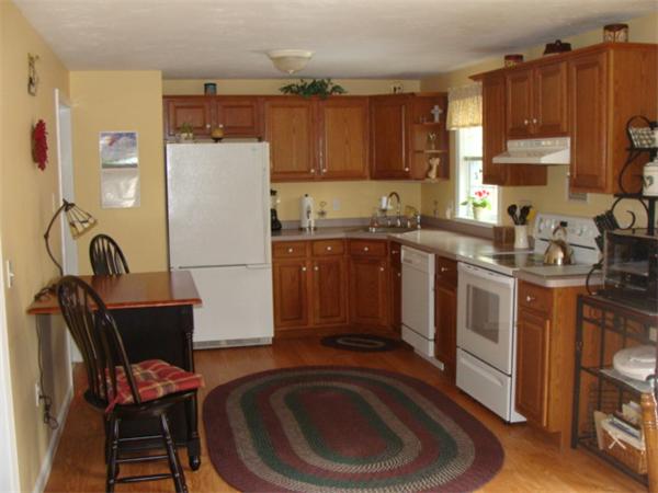 4 Kerri Lane Whitman, MA 02382 - Photo 7 of 30 a kitchen with stainless steel appliances granite countertop a stove a sink dishwasher and a refrigerator