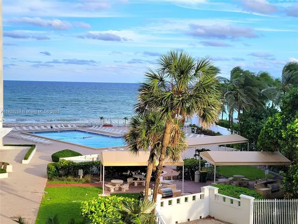a view of a patio with furniture and a garden