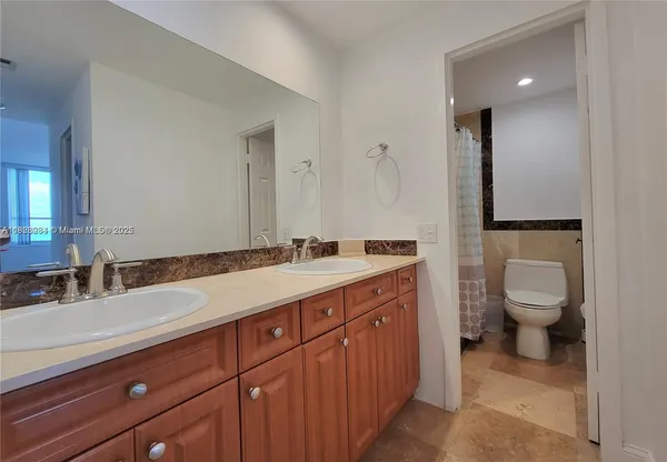 a bathroom with a sink a toilet and mirror