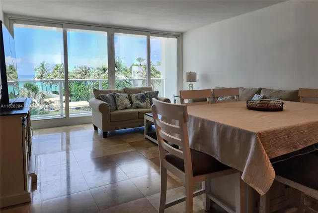 a living room with furniture and a floor to ceiling window