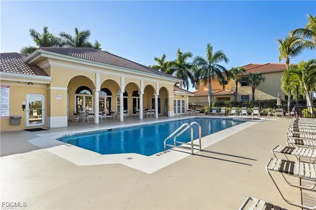 a view of a house with swimming pool and a porch with furniture