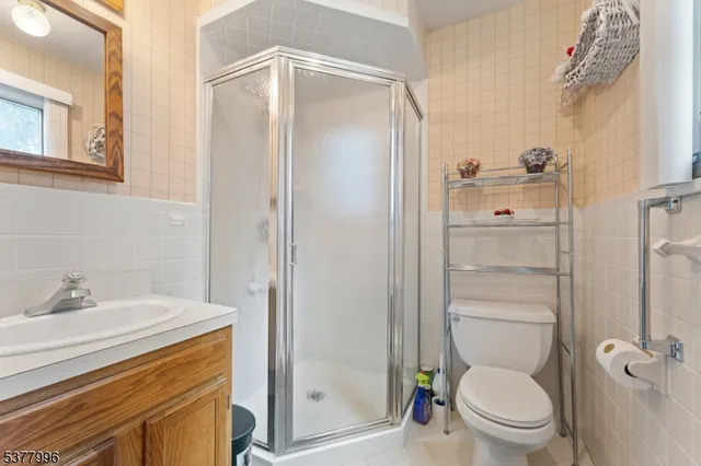 a bathroom with a shower a toilet and a sink