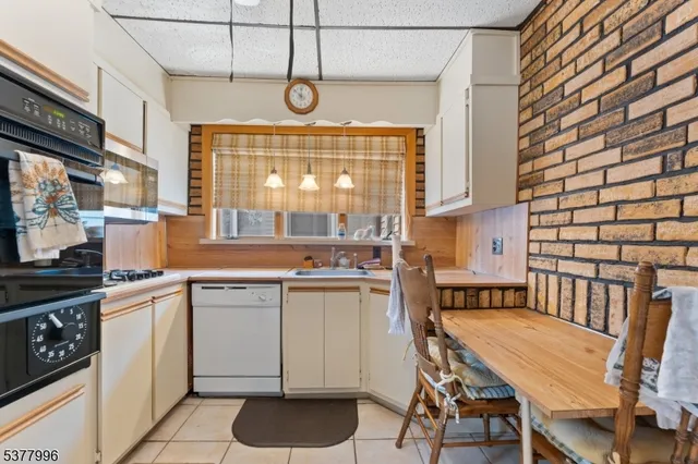 a kitchen with cabinets a sink and appliances