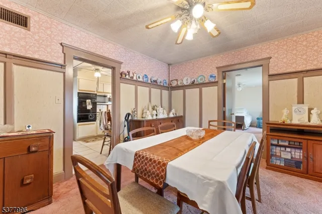 a large bedroom with a large bed and a chandelier