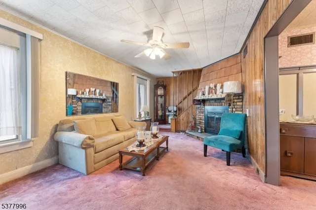 a living room with furniture and a fireplace