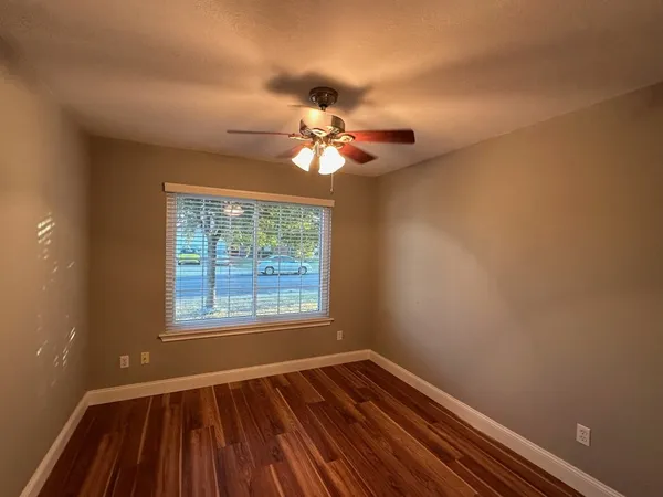 wooden floor in an empty room with a window