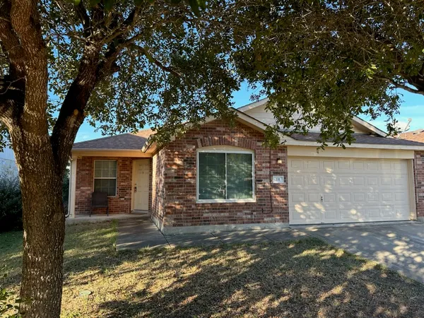 front view of a house with a tree