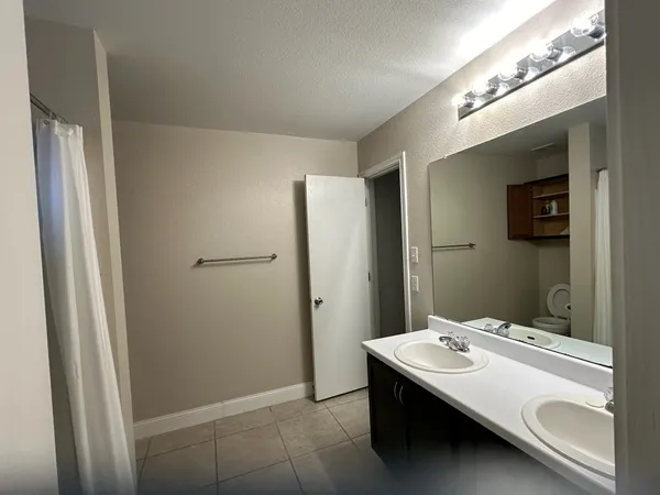 a bathroom with a sink a mirror and a shower