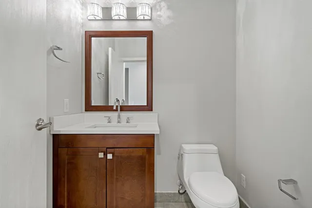 a bathroom with a toilet sink and mirror