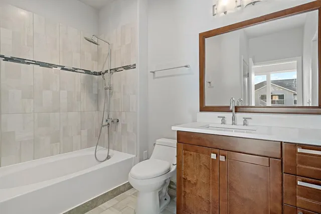 a bathroom with a sink toilet vanity and shower