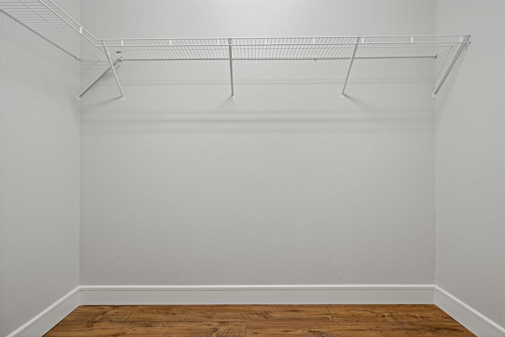 1220 West Trinity Mills Road, Unit 2011 Carrollton, TX 75006 - Photo 10 of 13 a view of a room with racks on the wall