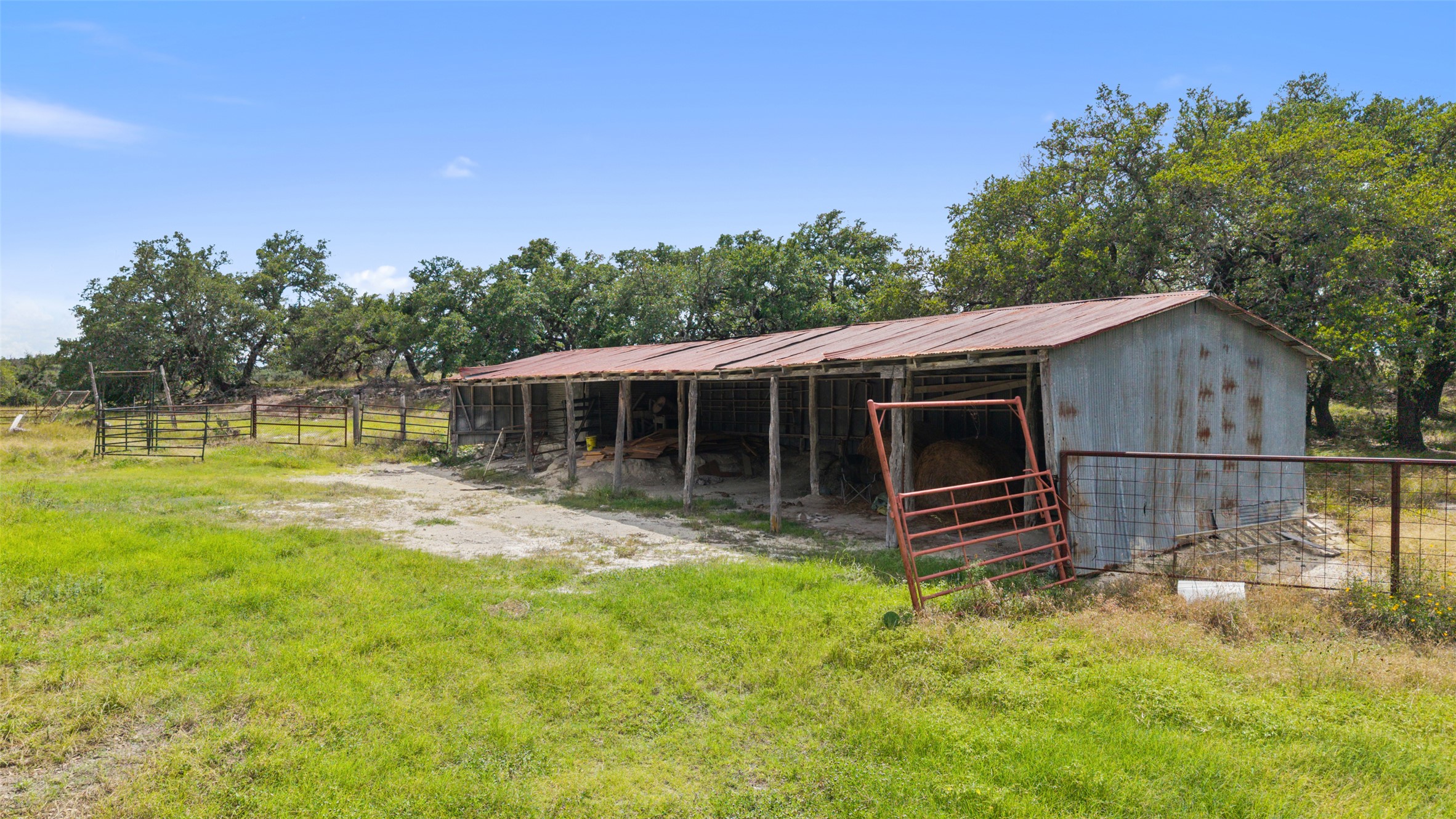 4112 Schumann Road Stonewall, TX 78671 - Photo 6 of 10 A spacious barn and fenced pasture provide ample room for livestock and agricultural pursuits.