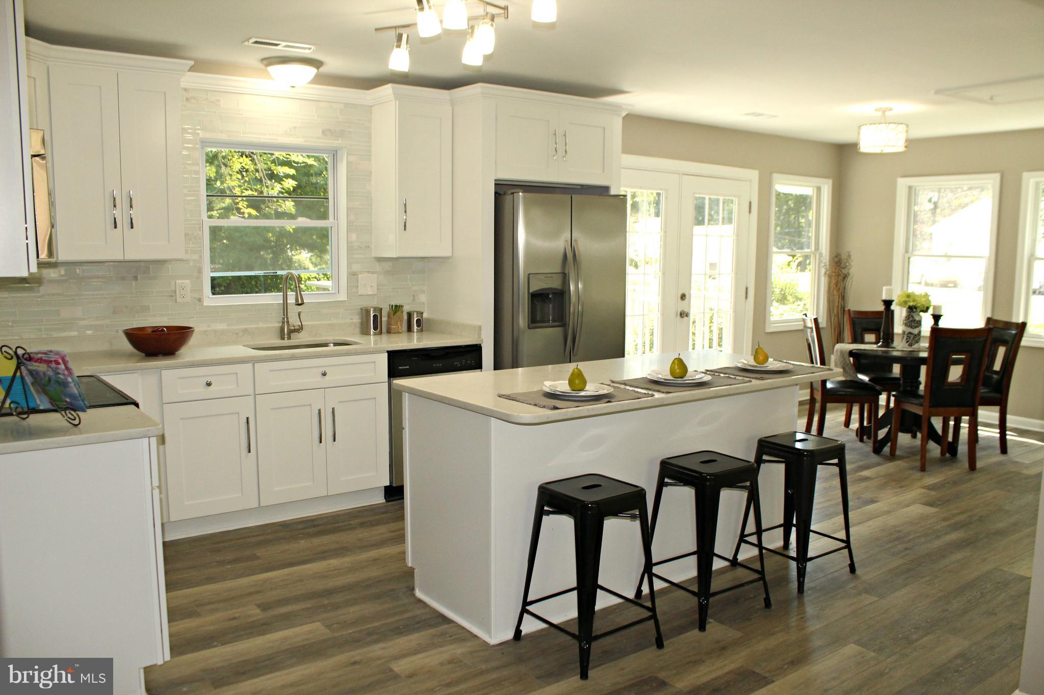 6104 Sam Riggs Road Laytonsville, MD 20882 - Photo 2 of 29 New kitchen with quartz and luxury vinyl plank!