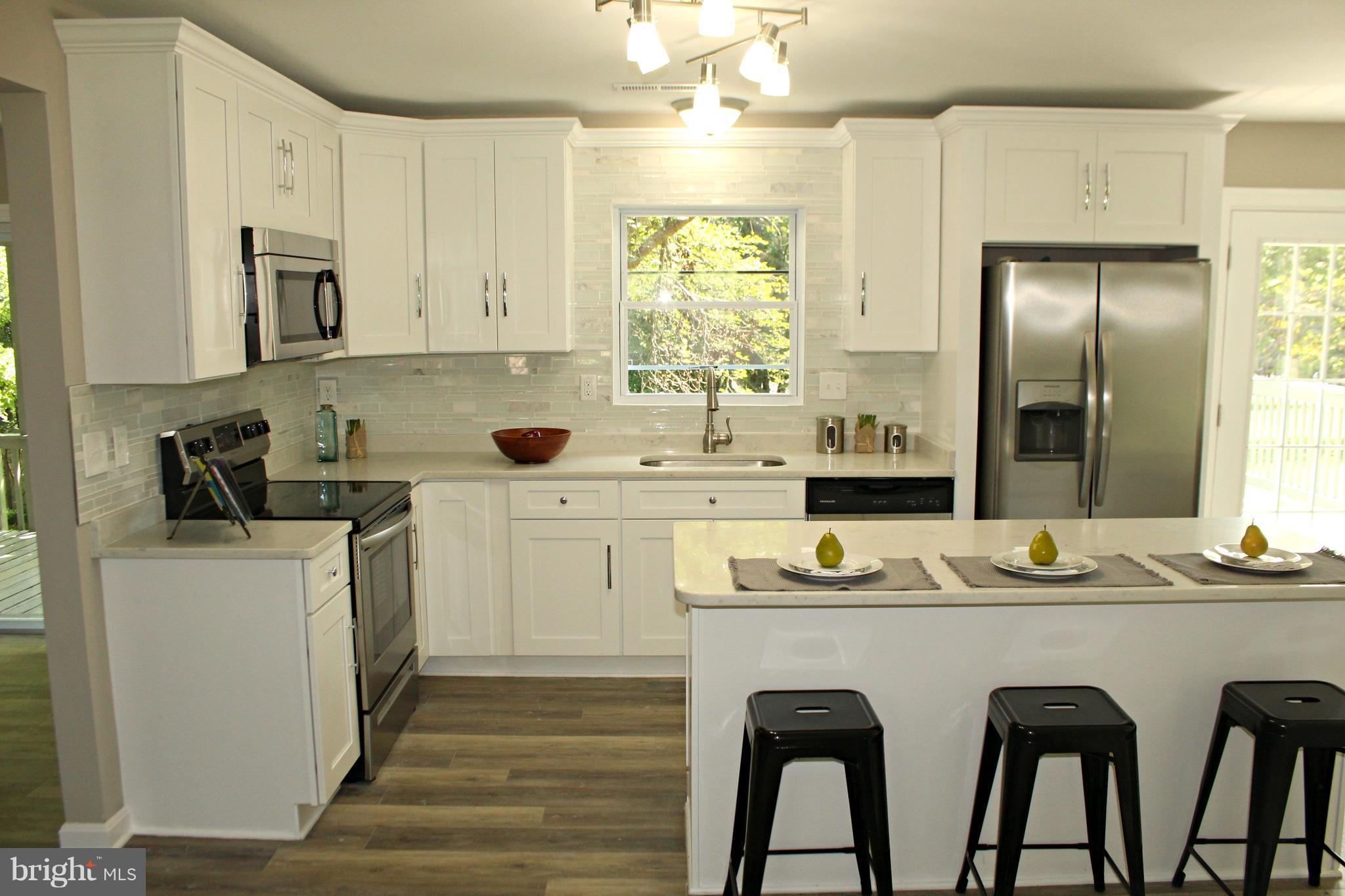 6104 Sam Riggs Road Laytonsville, MD 20882 - Photo 3 of 29 New kitchen with quartz and luxury vinyl plank!