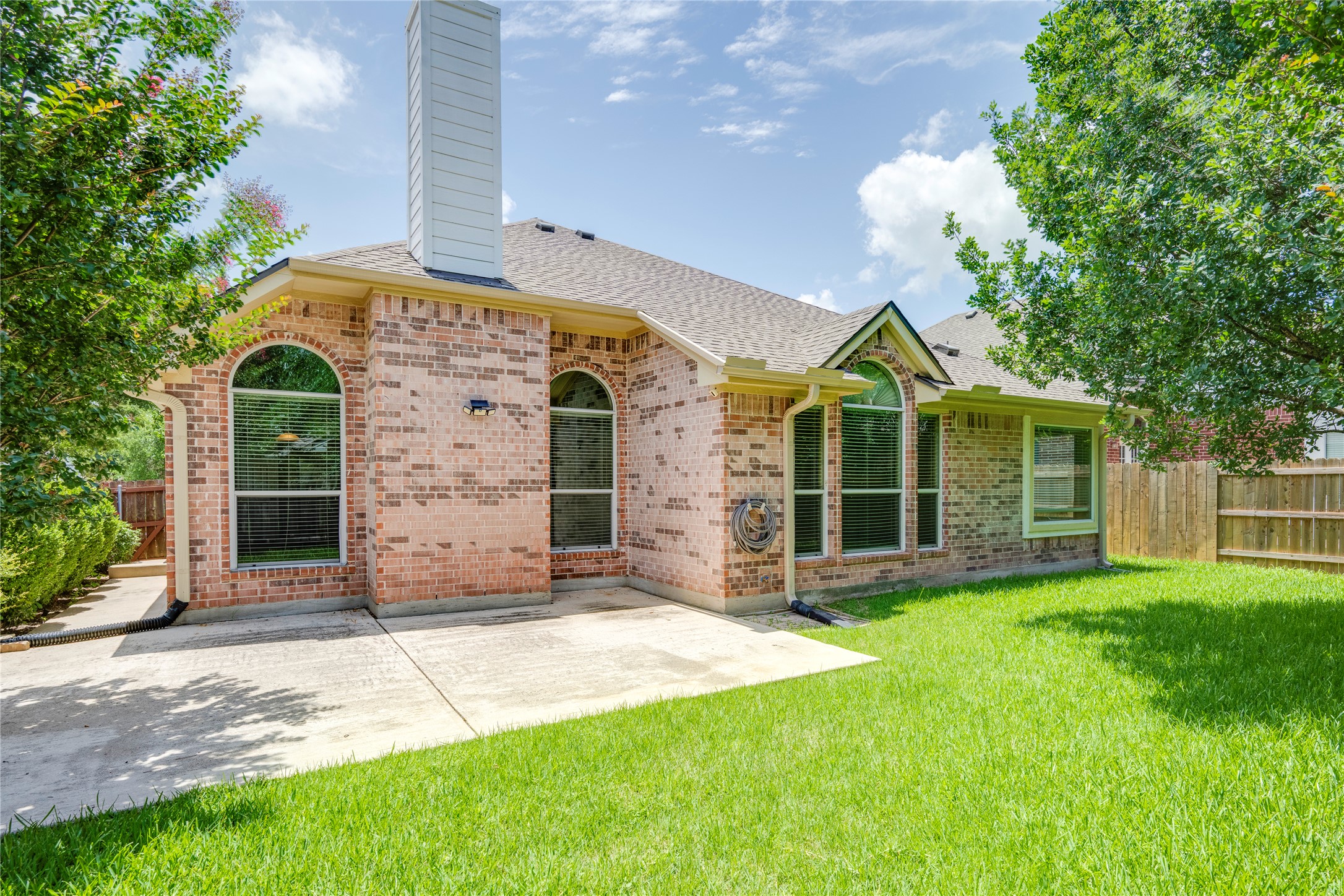 1813 Nelson Ranch Loop Cedar Park, TX 78613 - Photo 33 of 39 A well-maintained lawn and concrete patio complement this home's inviting brick exterior.