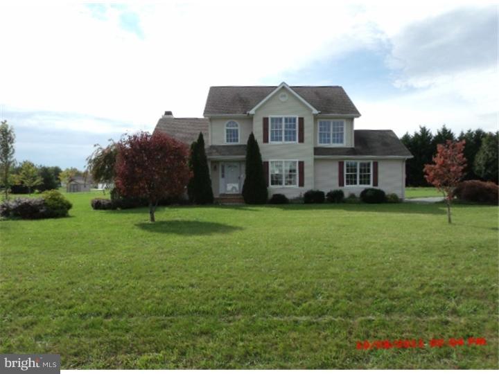 793 East Pebworth Road Magnolia, DE 19962 - Photo 1 of 12 a front view of a house with a garden and trees