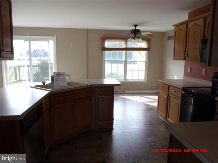 793 East Pebworth Road Magnolia, DE 19962 - Photo 3 of 12 a kitchen with granite countertop a stove a sink a window and wooden floor