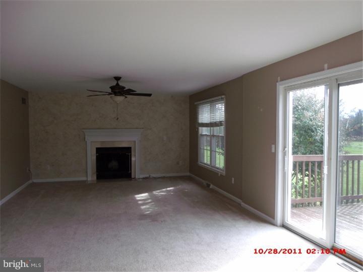 793 East Pebworth Road Magnolia, DE 19962 - Photo 5 of 12 a view of an empty room with a fireplace and a window