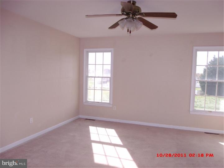 793 East Pebworth Road Magnolia, DE 19962 - Photo 7 of 12 an empty room with windows and fan