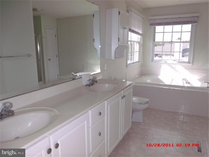 793 East Pebworth Road Magnolia, DE 19962 - Photo 8 of 12 a bathroom with a granite countertop sink and a large mirror