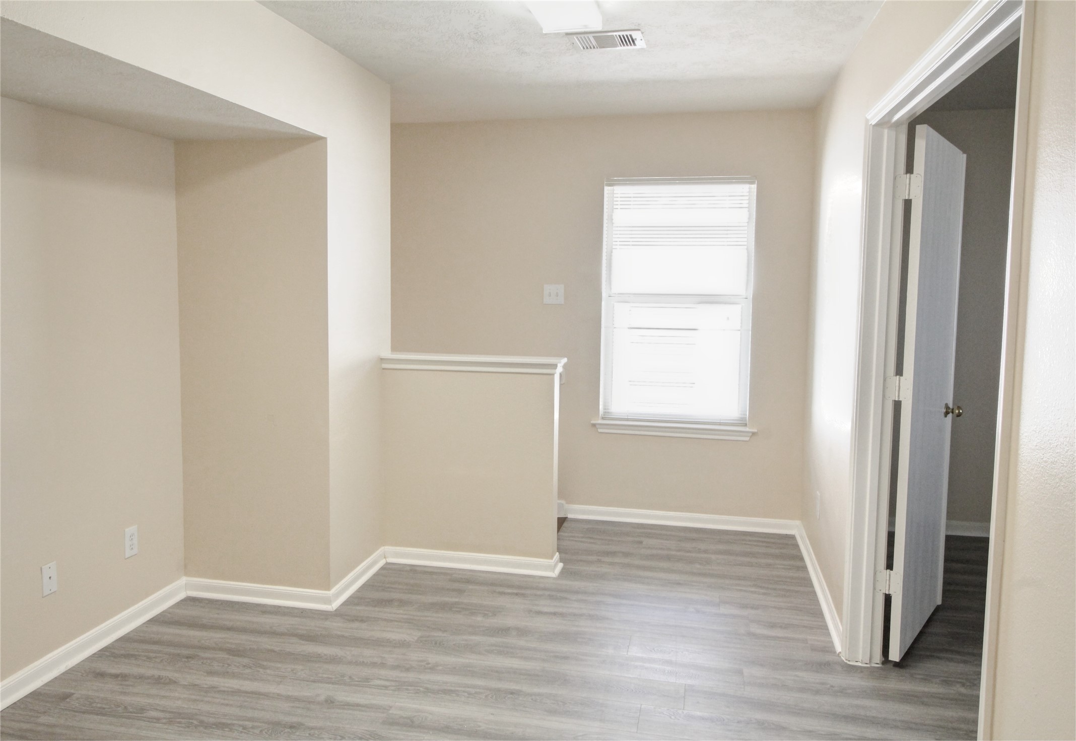 5530 Violet Path Lane Houston, TX 77085 - Photo 15 of 17 a view of an empty room with wooden floor and a window