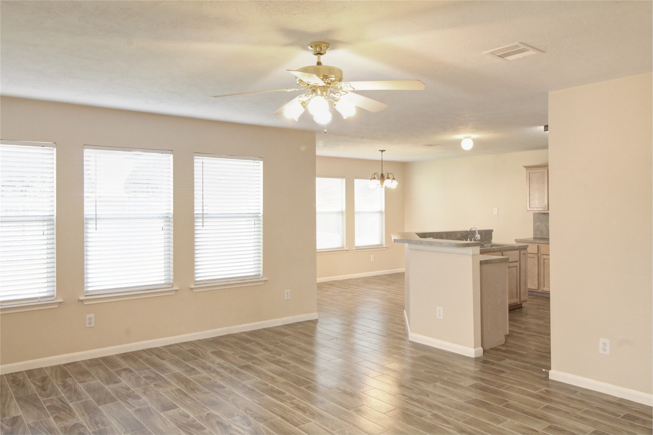 5530 Violet Path Lane Houston, TX 77085 - Photo 2 of 17 a view of an empty room with a window and wooden floor