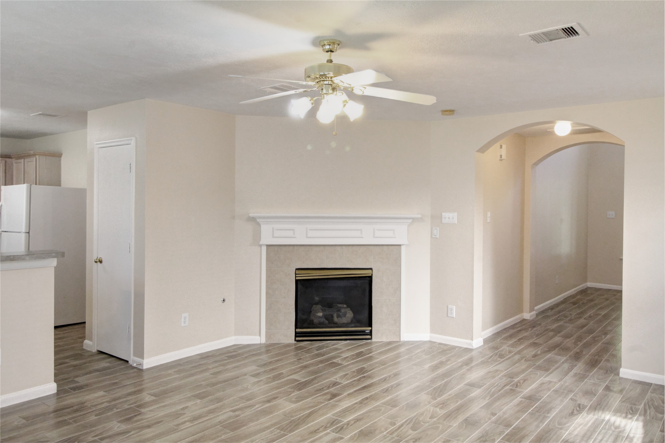 5530 Violet Path Lane Houston, TX 77085 - Photo 3 of 17 a view of an empty room with wooden floor and a fireplace