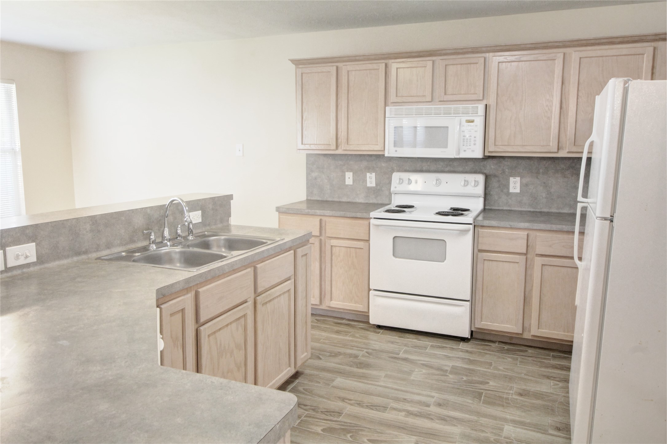 5530 Violet Path Lane Houston, TX 77085 - Photo 7 of 17 a kitchen with white cabinets stainless steel appliances and sink
