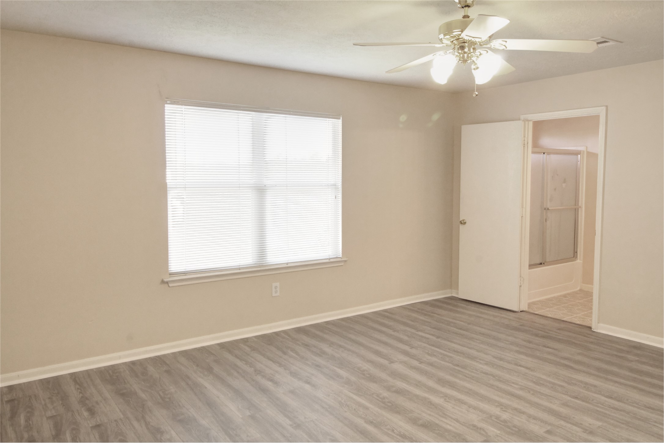 5530 Violet Path Lane Houston, TX 77085 - Photo 9 of 17 wooden floor in an empty room with a window