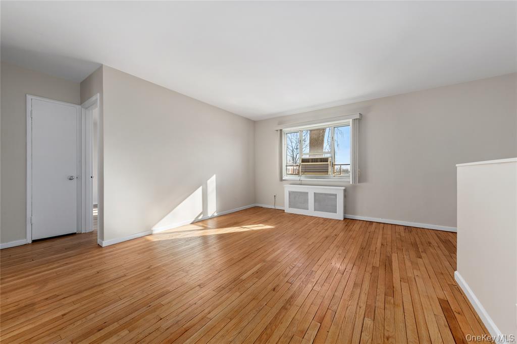220-06 Stronghurst Avenue, Unit UPPR Queens, NY 11427 - Photo 1 of 12 a view of empty room with wooden floor