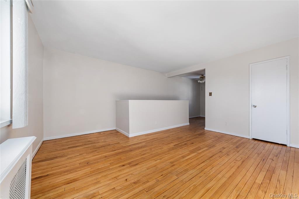 220-06 Stronghurst Avenue, Unit UPPR Queens, NY 11427 - Photo 3 of 12 a view of an empty room and wooden floor