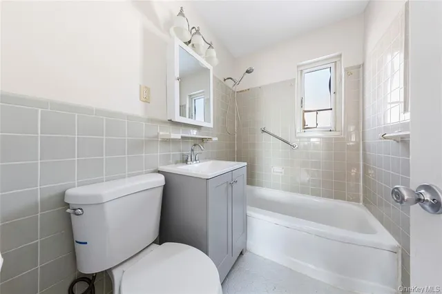 a bathroom with a toilet a sink and bathtub