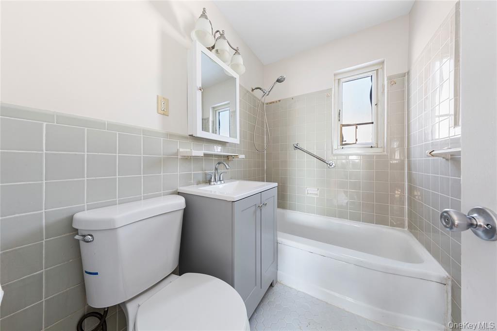 220-06 Stronghurst Avenue, Unit UPPR Queens, NY 11427 - Photo 10 of 12 a bathroom with a toilet a sink and bathtub